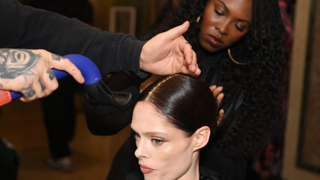 NEW YORK, NEW YORK - FEBRUARY 08: Head stylist Lacy Redway prepares Coco Rocha backstage for TRESemme X Christian Siriano at The Plaza on February 08, 2024 in New York City. (Photo by Dave Kotinsky/Getty Images for TRESemme)