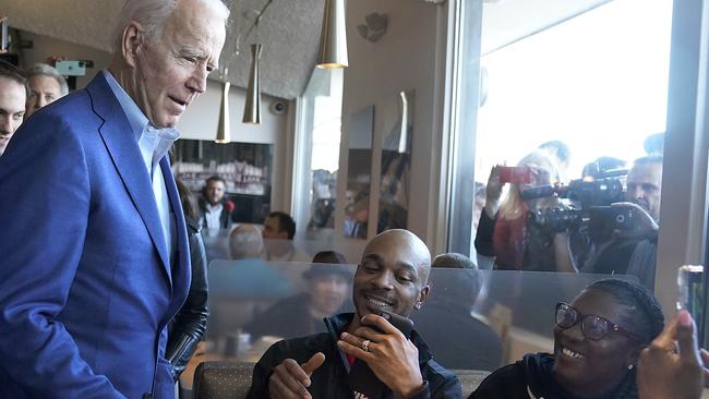 Joe Biden talks with diner customers in Oakland, California. Picture: AP.