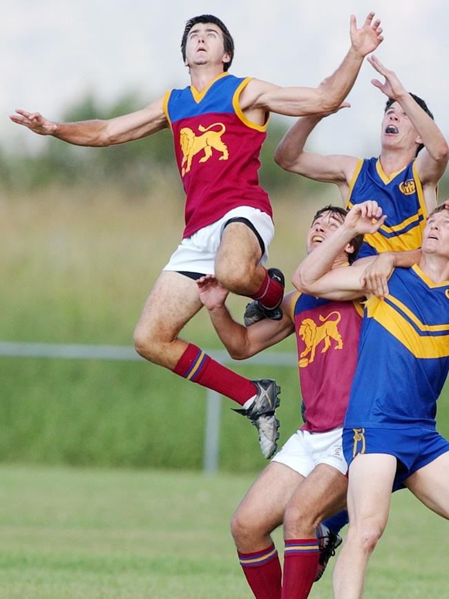 Ivan Walker (left) flies high for a marking contest in an interleague game between AFL Mackay and Townsville back in 2003. Picture: Stewart Mclean.