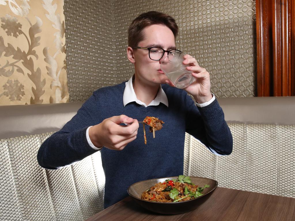 Courier Mail journalist Matthew Johnston eats Queensland's spiciest noodle dish at Fat Noodle restaurant at Treasury Casino. Picture: Zak Simmonds