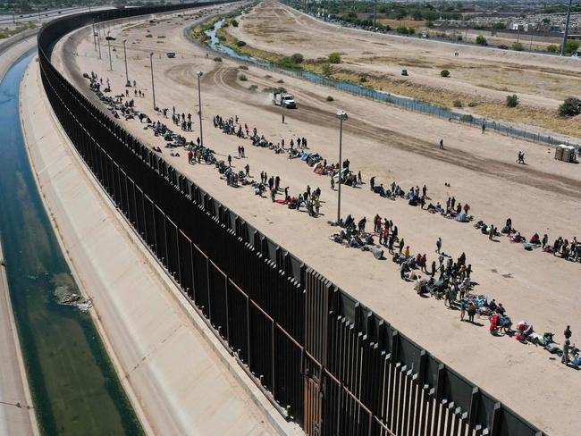 Migrants waiting to surrender to Border Patrol agents in El Paso, Texas last year. Picture: Patrick Fallon (AFP)