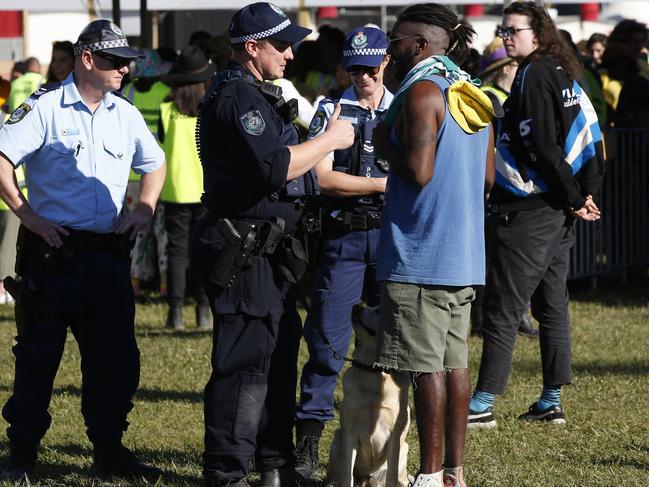 The police dog squad stop a punter during the festival. Picture: AAP/Regi Varghese.