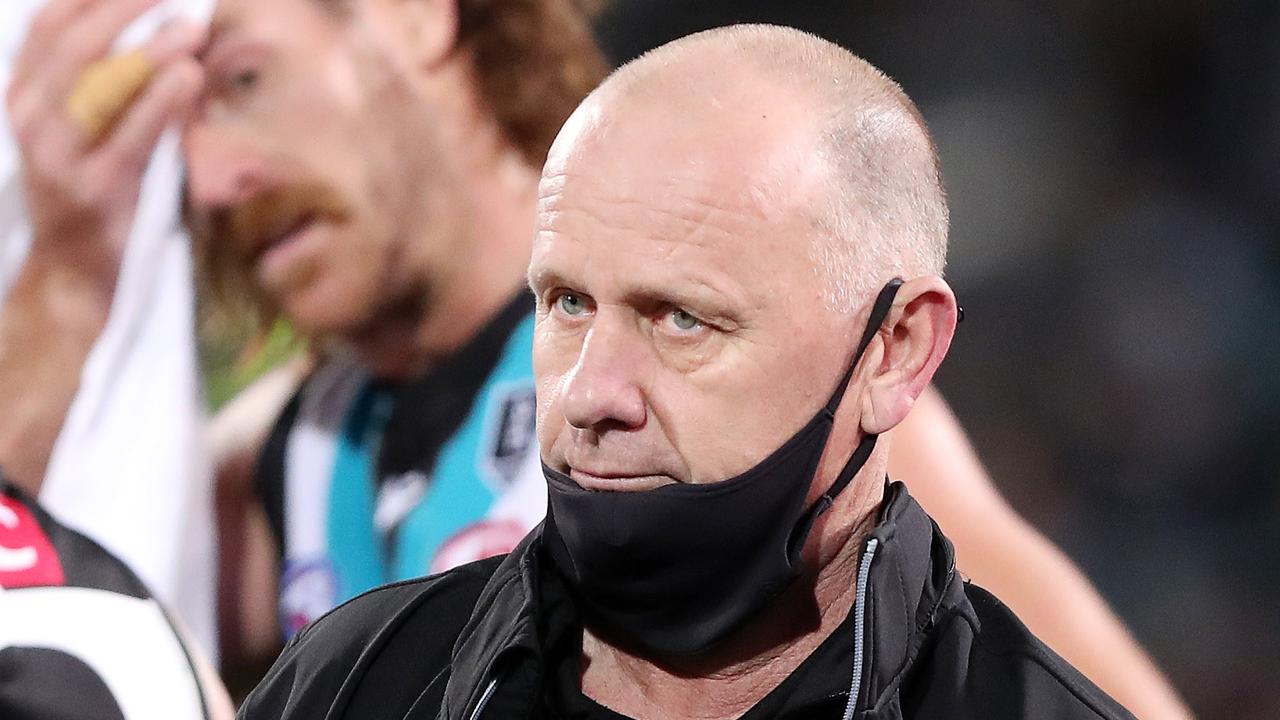 ADELAIDE, AUSTRALIA - SEPTEMBER 11: Ken Hinkley, Senior Coach of the Power at quarter time with Scott Lycett in the background during the 2021 AFL Second Preliminary Final match between the Port Adelaide Power and the Western Bulldogs at Adelaide Oval on September 11, 2021 in Adelaide, Australia. (Photo by Sarah Reed/AFL Photos via Getty Images)