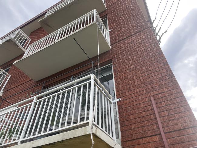 A measuring tape of about 3m was seen tied to the rail of a balcony where a two-year-old boy-old boy fell at Crawford St, Berala.