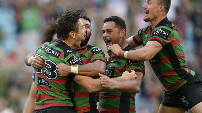 Cameron Murray of the Rabbitohs (left) celebrates with team mates after scoring a try during the Round 4 NRL match between the South Sydney Rabbitohs and the Canterbury-Bankstown Bulldogs at ANZ Stadium in Sydney, Friday, March 30, 2018. (AAP Image/Dan Himbrechts) NO ARCHIVING, EDITORIAL USE ONLY