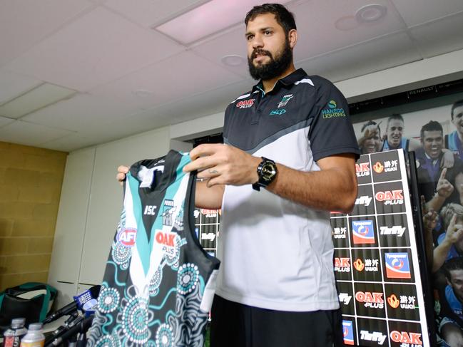 Port Adelaide Ruckman Paddy Ryder is seen holding the Sir Douglas Nicholls Indigenous Round guernsey after a media conference at Port Adelaide's home ground at Alberton in Adelaide, Monday, May 28, 2018. (AAP Image/Morgan Sette) NO ARCHIVING