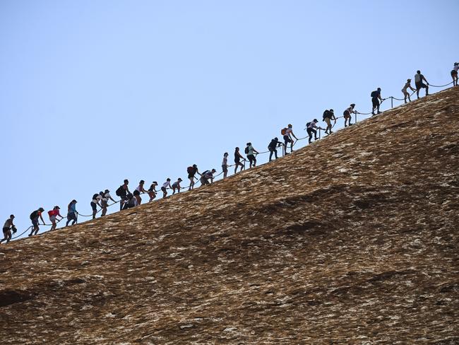 Tourists climbing Uluru on Friday, the last day it was allowed Picture: Lukas Coch/AAP