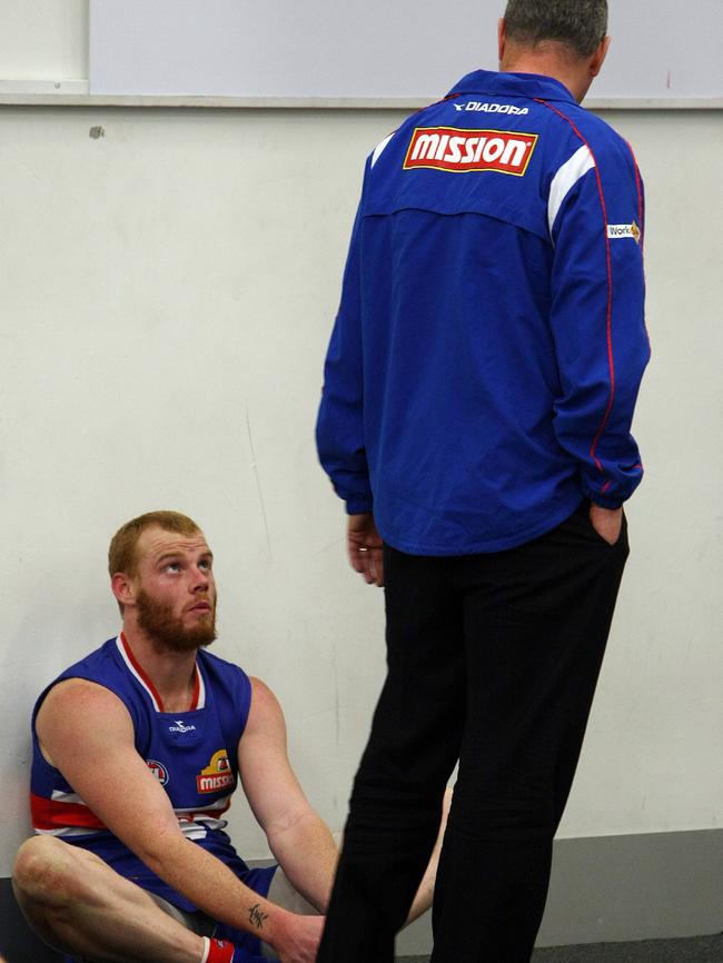 Rodney Eade talks with Adam Cooney after a loss