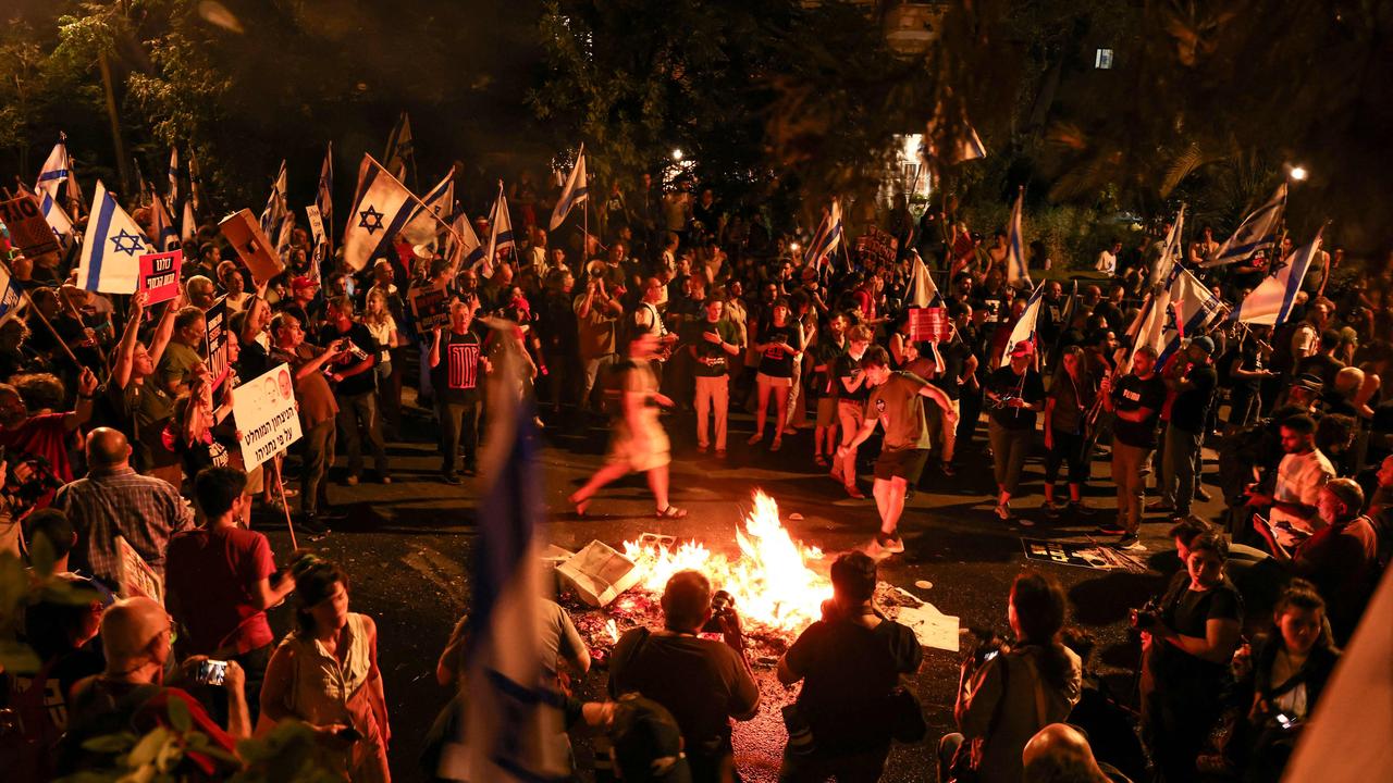 Protesters set a fire near the residence of the Israeli prime minister during an anti-government rally calling for early elections, in Jerusalem. Picture: AFP