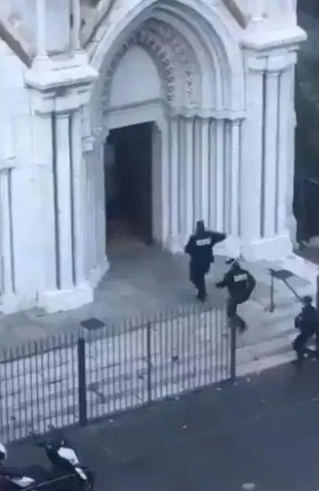 Police enter the Notre Dame church in Nice.