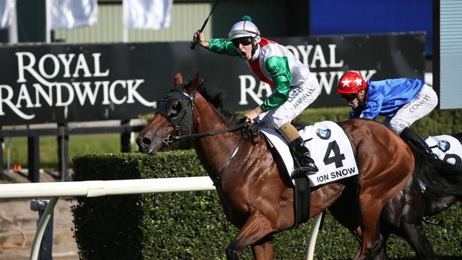 Jockey Damien Lane on Jon Snow shouts out to the crowds as they win the BMW Australian Derby