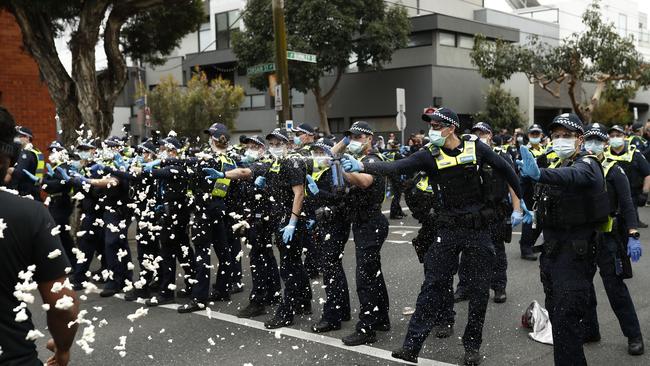 MELBOURNE, AUSTRALIA - SEPTEMBER 18: Police deploy capsicum spray onto protestors on Burnley Street Richmond on September 18, 2021 in Melbourne, Australia. Anti-lockdown protesters gathered despite current COVID-19 restrictions prohibiting large outdoor gatherings. Metropolitan Melbourne is currently subject to lockdown restrictions as health authorities work to contain the spread of the highly contagious Delta COVID-19 variant, with people only permitted to leave their homes for essential reasons. Victorian COVID-19 restrictions have been eased from today in Metropolitan Melbourne to allow outdoor picnics and small exercise groups, while the permitted travel distance from home has extended to 10km.  (Photo by Darrian Traynor/Getty Images)