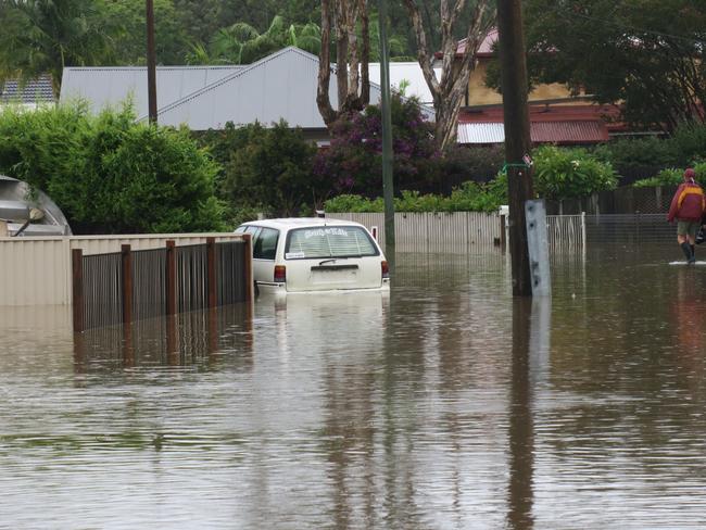 This car didn’t make it out in time on Geoffrey Rd, Chittaway, after torrential rain over the weekend. Picture: Richard Noone