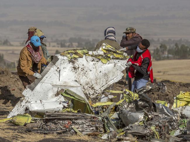 FILE - In this March 11, 2019, file photo, rescuers work at the scene of an Ethiopian Airlines flight crash near Bishoftu, Ethiopia. A published report says pilots of an Ethiopian airliner that crashed followed Boeingâ€™s emergency steps for dealing with a sudden nose-down turn but couldnâ€™t regain control. (AP Photo/Mulugeta Ayene, File)