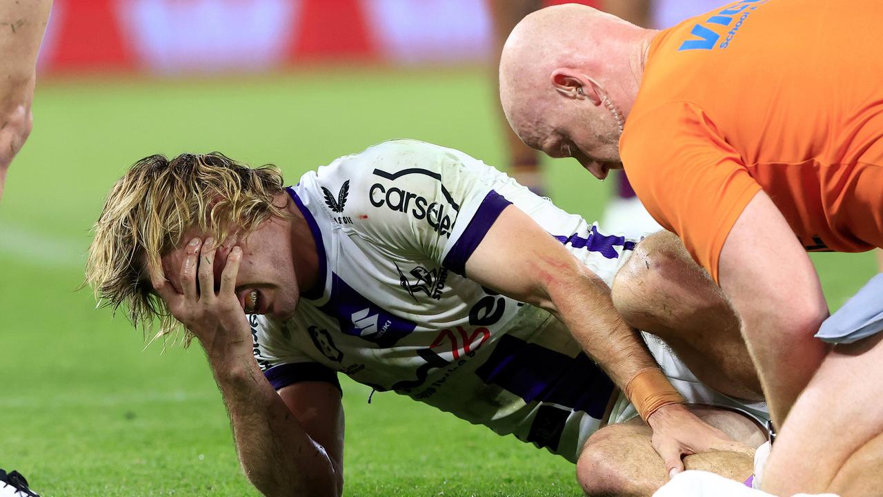 Papenhuyzen grimaces as he’s treated on the pitch. Picture: Adam Head