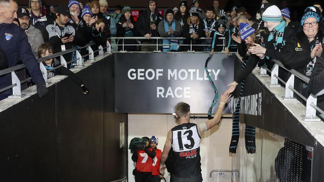 Fans gather around Todd Marshall as he goes down the race after the win over the Western Bulldogs. Picture: Sarah Reed.