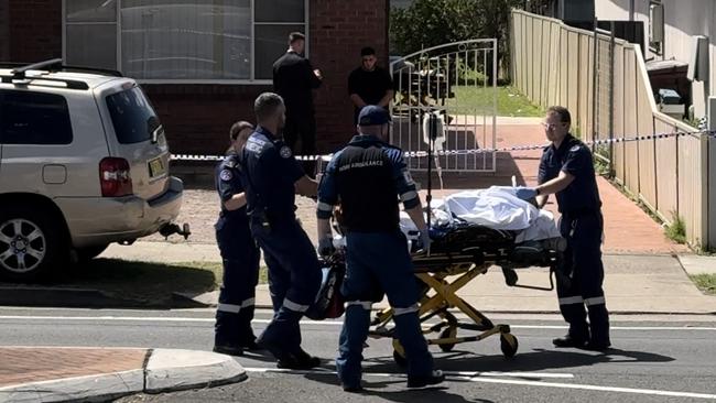 Paramedics help a man into an ambulance on Sunday.