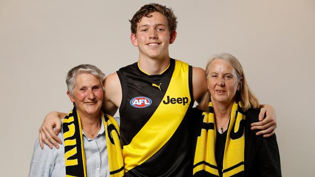 Riley Collier-Dawkins with his two mums Chris (left) and Jacinta, after joining the Tigers. Pic: Getty Images