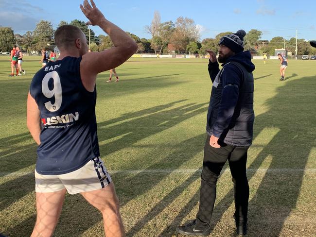 Edi-Asp coach Ben Walker (right) celebrates with player Trent Robertson (No.9) moments after the siren on Saturday.