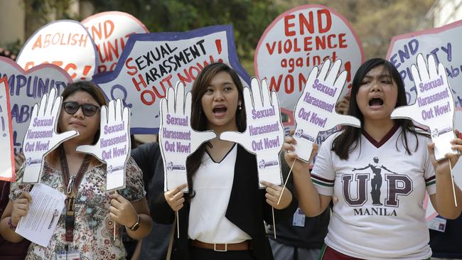 Filipino students hold slogans against sexual harassment and alleged increase in cases of violence committed against young women during a rally outside their school in Manila, Philippines, leading up to International Women's Day. (Pic: AP Photo/Aaron Favila)