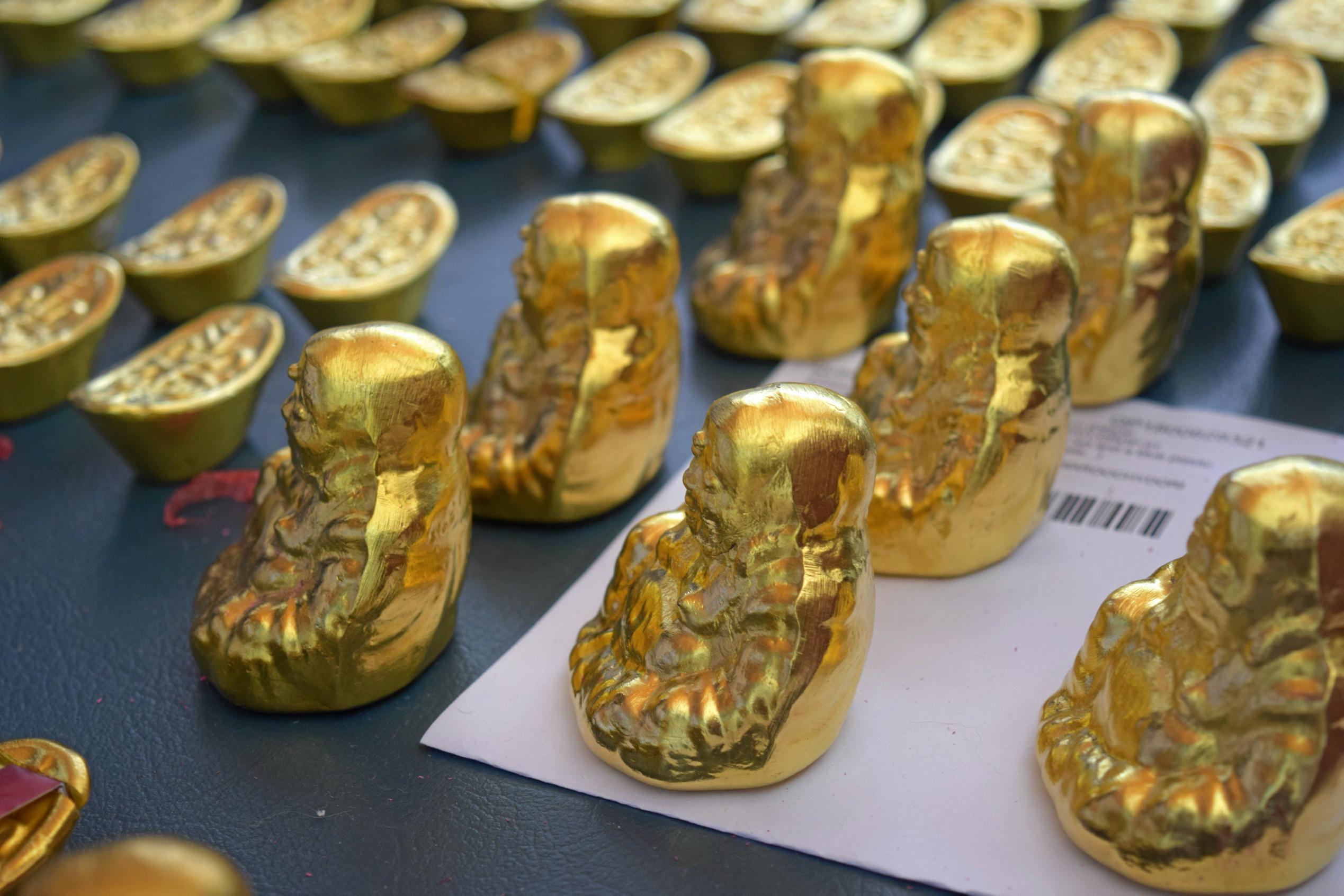 Fake gold Buddha statues and ingots seized by police are alleged to have been used to scam people. Picture: Chloe Lyons