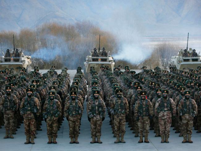 (FILES) In this file photo taken on January 4, 2021, Chinese People's Liberation Army (PLA) soldiers assemble during military training at Pamir Mountains in Kashgar, northwestern China's Xinjiang region. - During Xi Jinping's decade-long rule China has built the world's largest navy, revamped the world's largest standing army and amassed a nuclear and ballistic arsenal to trouble any foe. (Photo by AFP) / China OUT / TO GO WITH China-Xi-congress-military-Asia Pacific, FOCUS by Andrew BEATTY