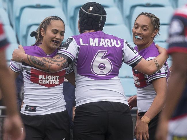 First try, first Warriors captain. Hilda Mariu (left) and her wife Laura (centre). Pic: AAP