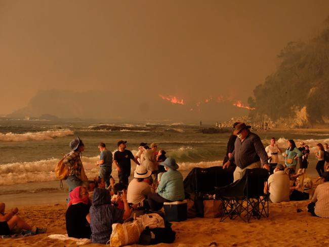 Bushfire arrives into the township of Malua Bay NSW, just south of Batemans Bay. Locals seek refuge on the beach as the fire approaches. Picture: Alex Coppel