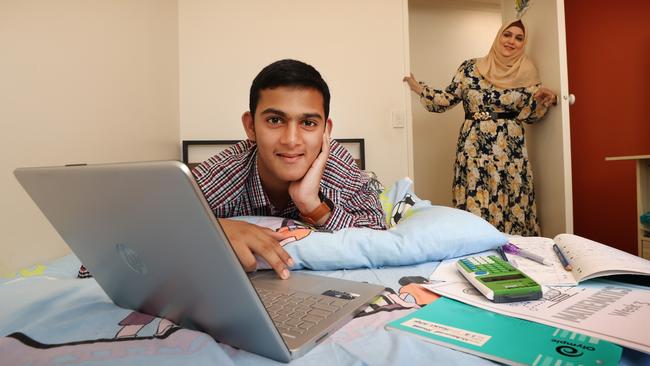 Mohammad studies in his room under the watchful eye of his mother Ayesha Khan. Picture: David Caird