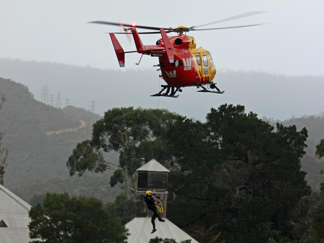 Then the Westpac chopper was called to retrieve a 15-year-old boy stranded on an inundated cricket oval at Tynwald Park in New Norfolk during the flood. Picture: DAMIAN BESTER