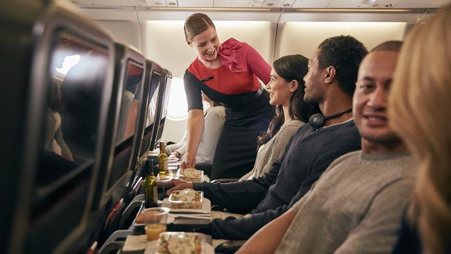 From Jan 20, Qantas will be offering direct seasonal flights from Sydney to Sapporo’s New Chitose Airport, to help make it easier for travellers to reach Hokkaido’s world-class ski resorts on Japan's northernmost island. Picture: Supplied/Qantas.    Inflight economy cabin passengers are getting food served in Qantas A330