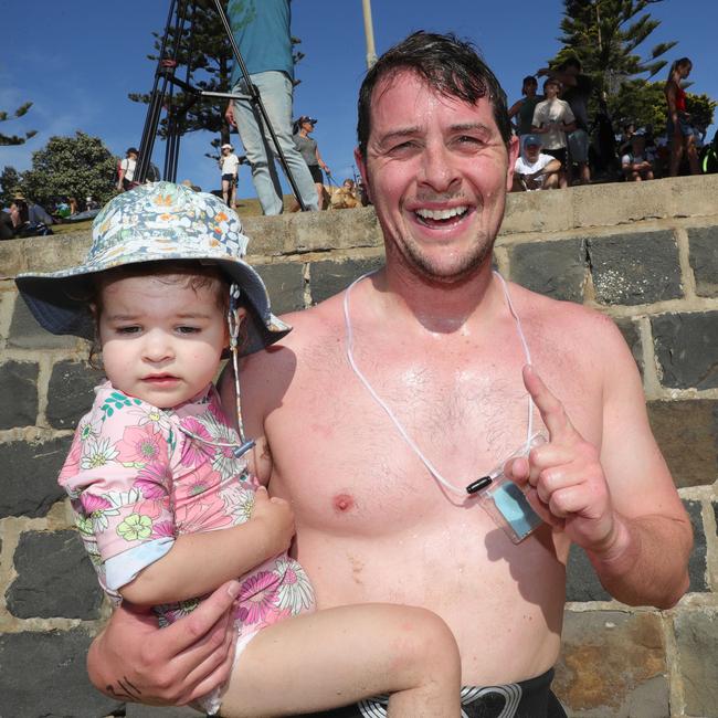 Sam Sheppard with daughter Ollie, 2, after winning the 2.km Danger 1000 swim in Torquay this month. Picture: Mark Wilson