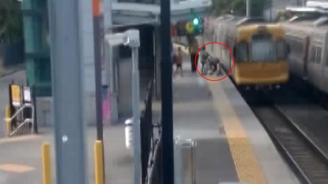 Footage of a toddler falling through the train tracks while their mum holds a pram at Alderley Station has been released. Picture: Queensland Rail.