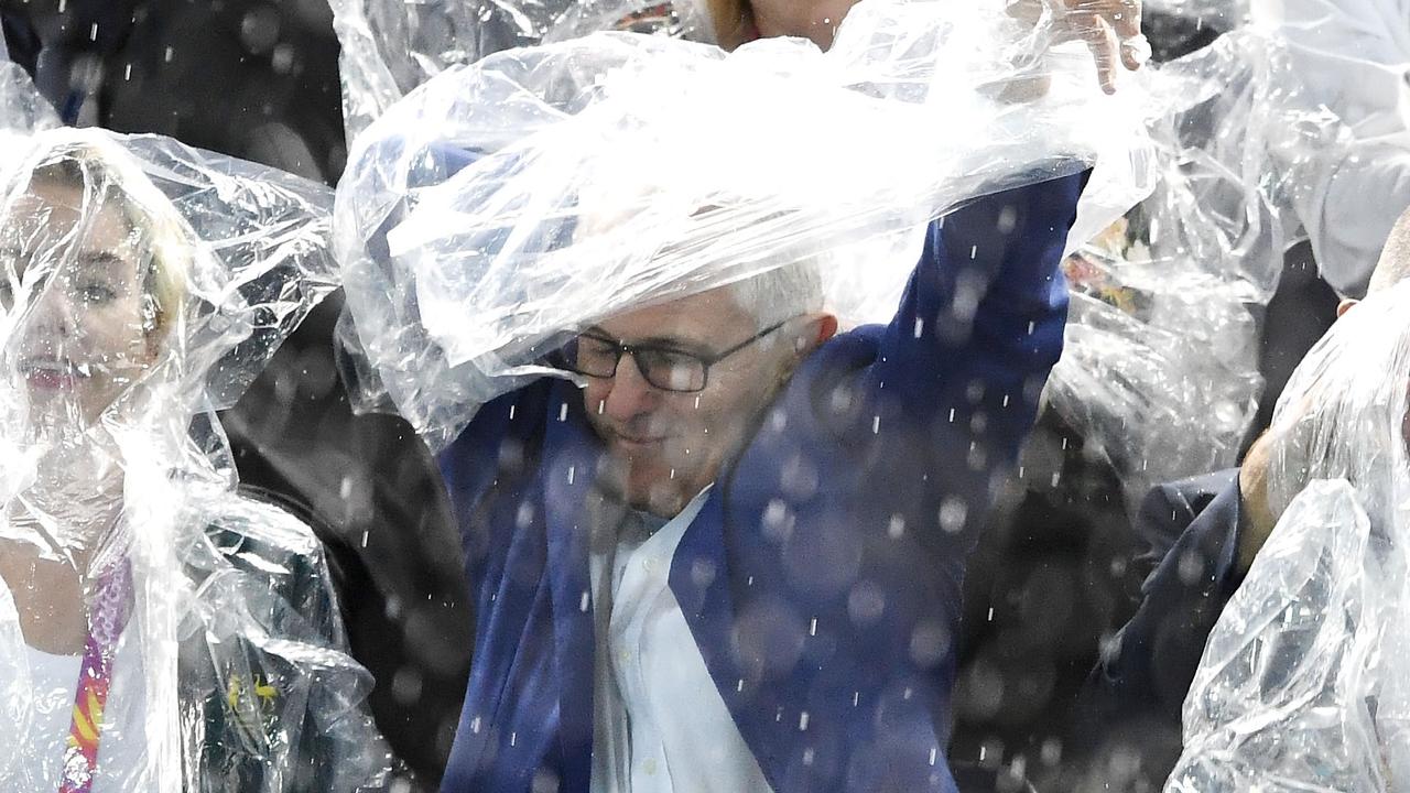 Malcolm Turnbull caugh in the rain and gladly accepted the free poncho.