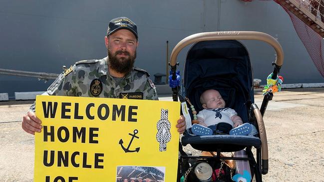 Cairns-local boatswains mate Able Seaman Joseph Parsons is welcomed home by his nephew Jack Littlewood during HMAS Supply II's first port visit to Cairns. Picture: Supplied