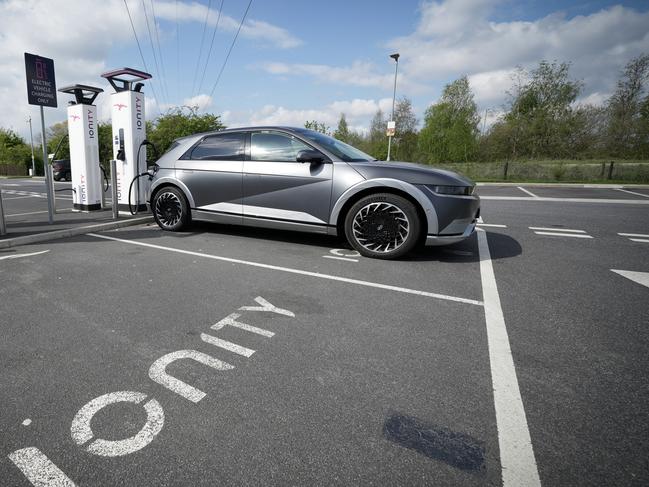 LEEDS, ENGLAND - APRIL 26: A Hyundai Ioniq battery electric vehicle (BEV) charges at an Ionity GmbH electric car charging station at Skelton Lake motorway service area on April 26, 2022 in Leeds, England. According to a report from the Society of Motor Manufacturers And Traders, there were more new electric vehicle registrations in the UK in March 2022 than all of 2019. However, overall car sales slumped amid rising fuel prices and the car industry's supply chain problems. (Photo by Christopher Furlong/Getty Images)