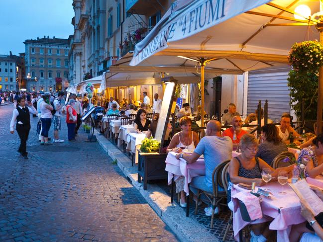 ESCAPE: Rome.  Rome, Italy - Sep 16, 2015: Tourists and local residents enjoying the night life, dining in outdoor street restaurants in the center of Rome, Italy.