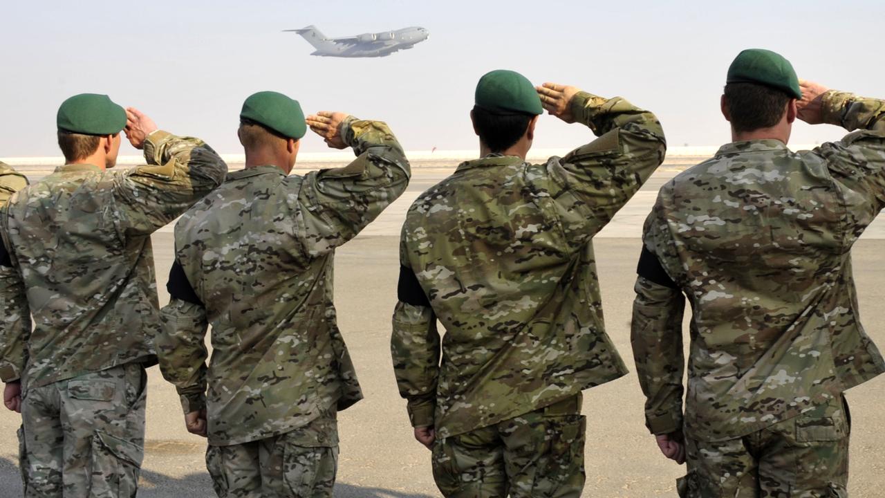 Australian Army soldiers from Special Operations Task Group salute a fallen mate killed in conflict, as an RAAF C-17 aircraft departs Al Minhad Air Base, United Arab Emirates. Picture: Department of Defence