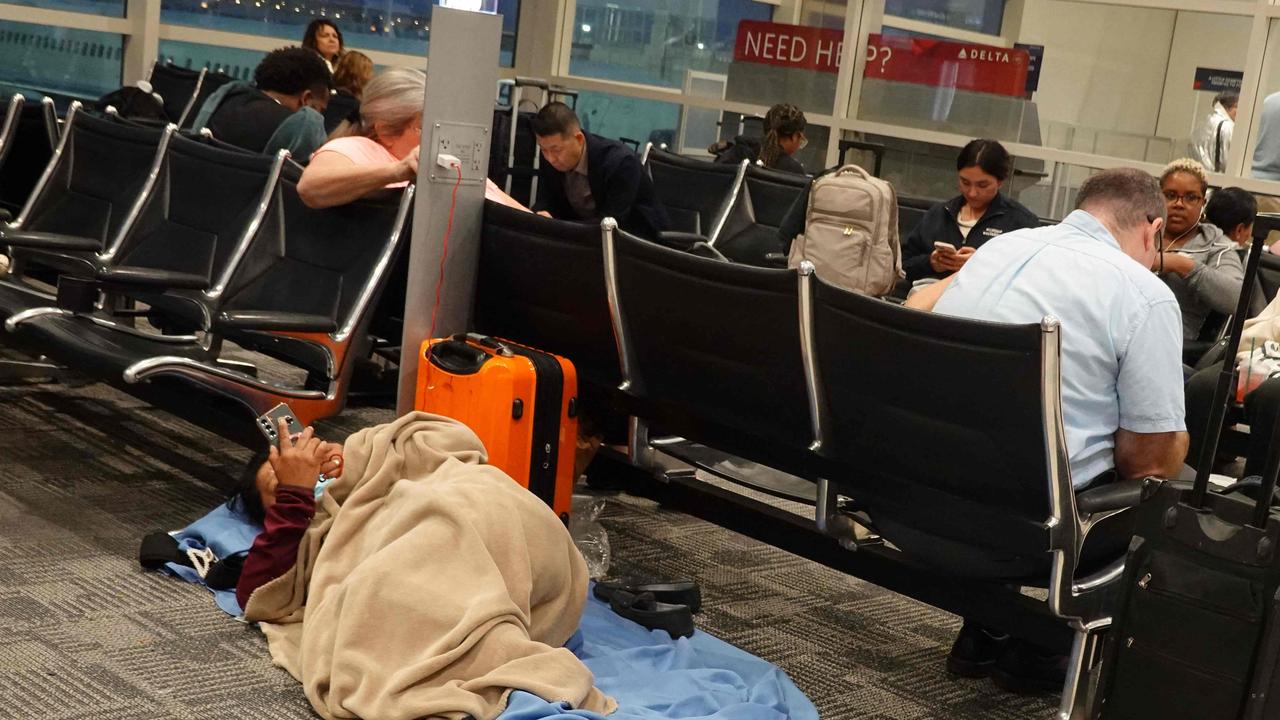 Travelers rest in a US airport two days after many travellers were rerouted or had their flights cancelled as airlines slowly come back online, following the CrowdStrike outage. Picture: Joe Raedle/Getty Images/AFP