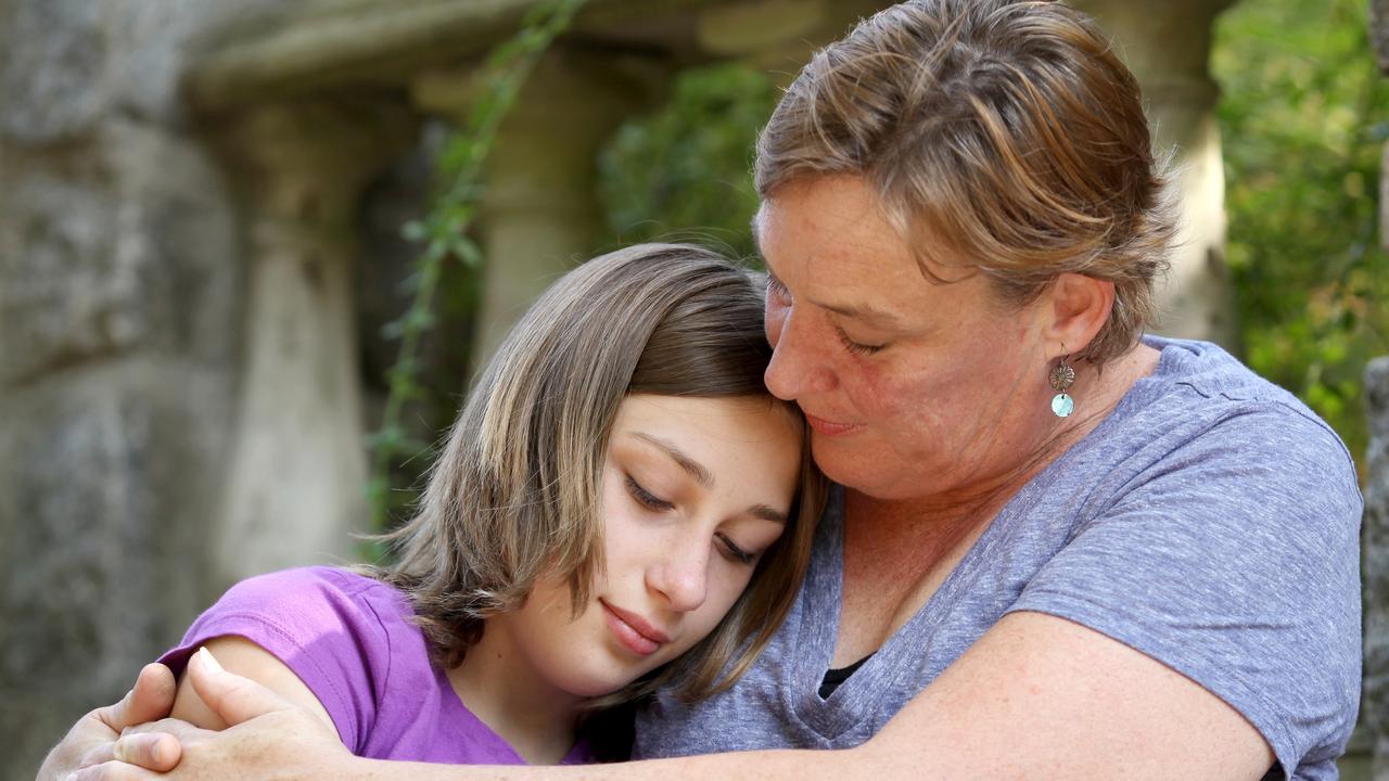 Mother consoling her teenage daughter.