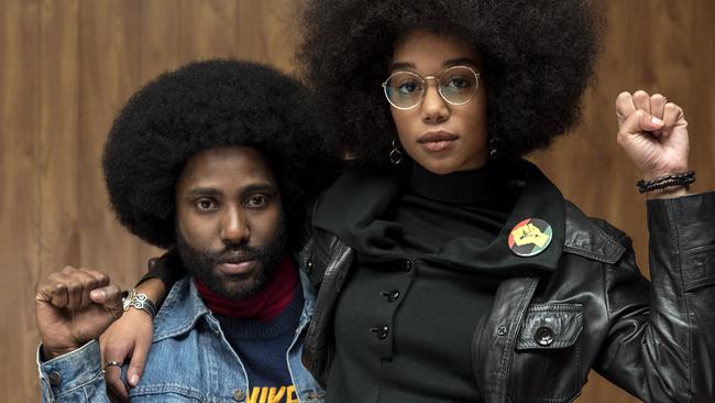 This image released by Focus Features shows John David Washington, left, and Laura Harrier in a scene from "BlacKkKlansman." (David Lee/Focus Features via AP)