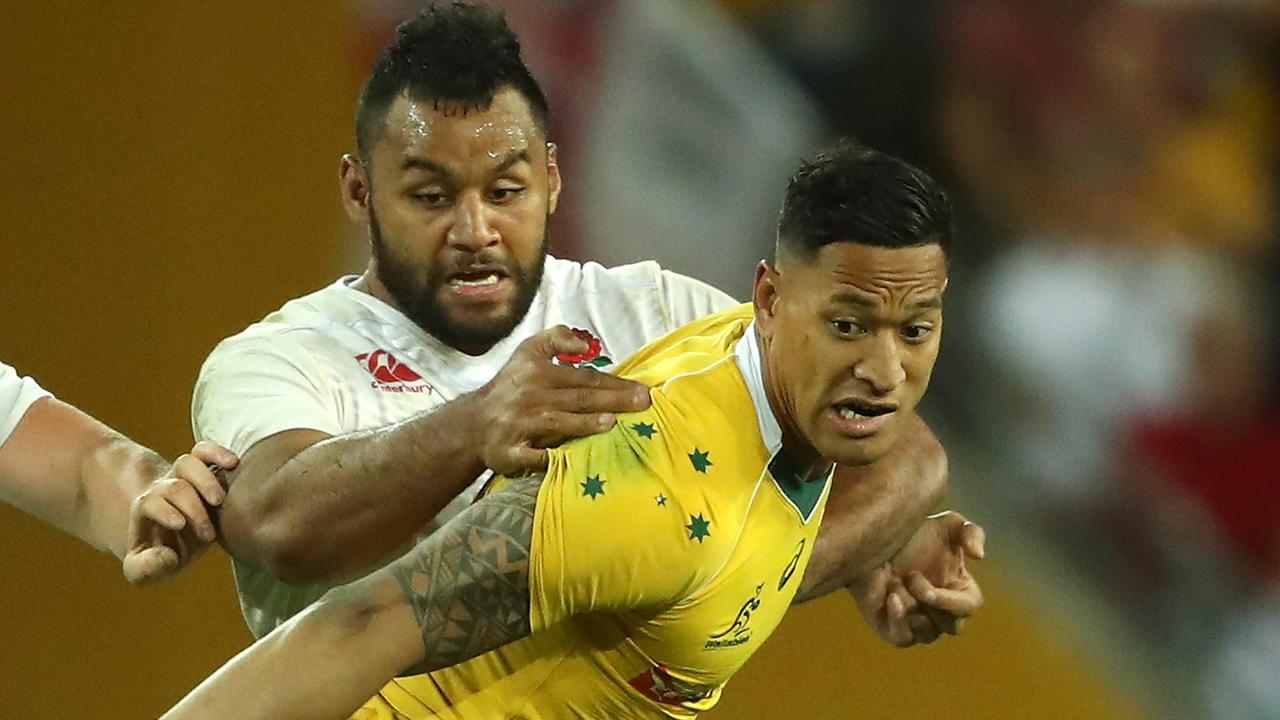 Israel Folau of Australia is held by Billy Vunipola at Suncorp Stadium.