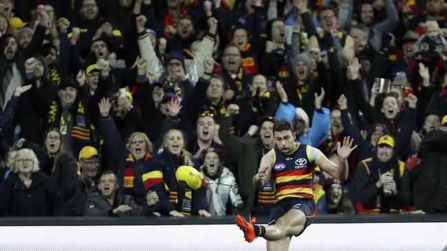 Crows fans celebrate the win as Rory Atkins has a kick after the siren. Picture SARAH REED