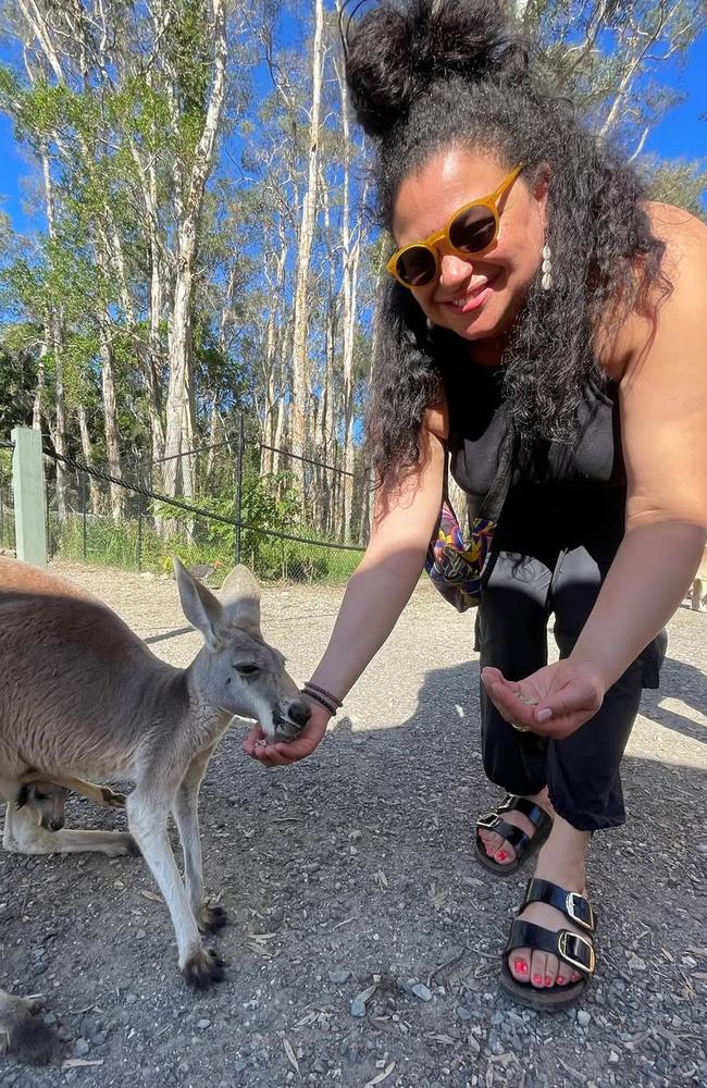Michelle Buteau feeding a wallaby while filming in Queensland. Photo: Instagram.