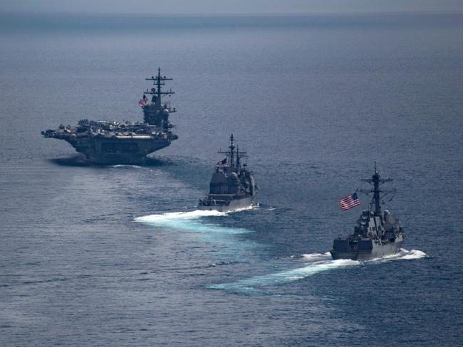 USS Carl Vinson (left) leading the Arleigh Burke-class guided-missile destroyer USS Michael Murphy (centre) and the Ticonderoga-class guided-missile cruiser USS Lake Champlain in the Indian Ocean on April 14, 2017. Picture: Danny Kelley/US Navy/AFP