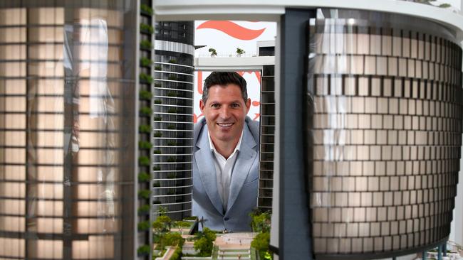 The Queens Wharf Residences head of residential sales Bryce O'Connor peering through one of the four models of the Queen’s Wharf integrated resort. Picture: AAP/David Clark