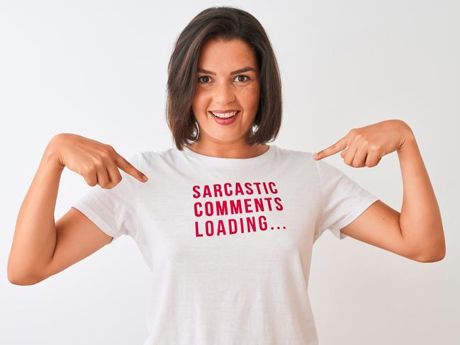 Young beautiful woman wearing fanny t-shirt standing over isolated white background very happy pointing with hand and finger