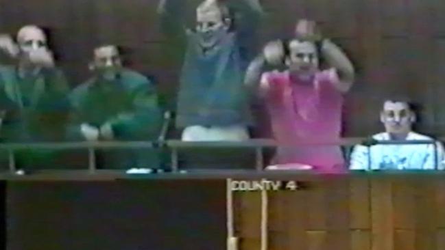 Video still from a trial at the County Court in September 2000. The Trial from Hell. (L to R) Matthew Johnson, Stephen Wenitong, Prisoner 3, Sean Sonnett and John Lindrea launch into a Mexican wave.