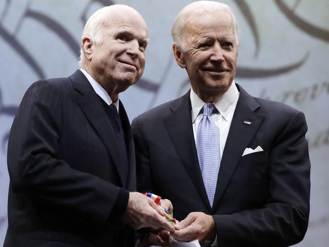 Senator John McCain (left) receives the Liberty Medal from Chair of the National Constitution Centre's Board of Trustees, former Vice President Joe Biden, in Philadelphia. Picture: AP Photo/Matt Rourke