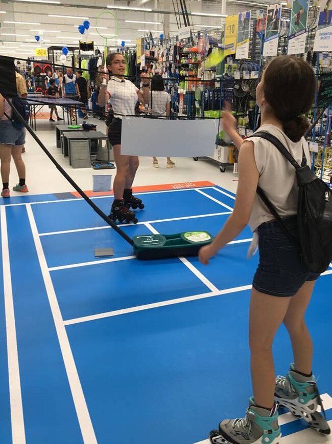 Customers trying out sporting equipment.